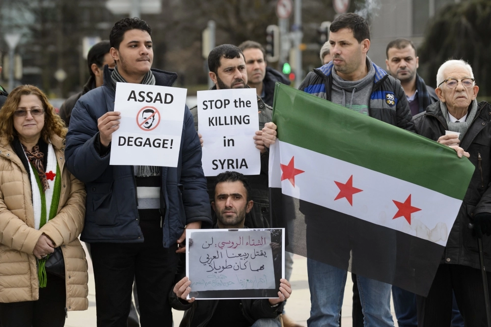 سوريون يتظاهرون ضد قتل المدنيين في جنيف (أ ف ب)