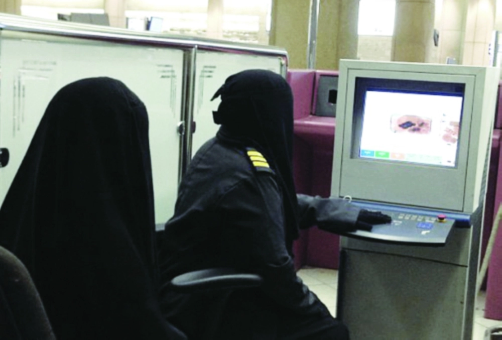 موظفة جمارك تفحص حقيبة مسافرة في مطار الملك خالد  (مكة)
