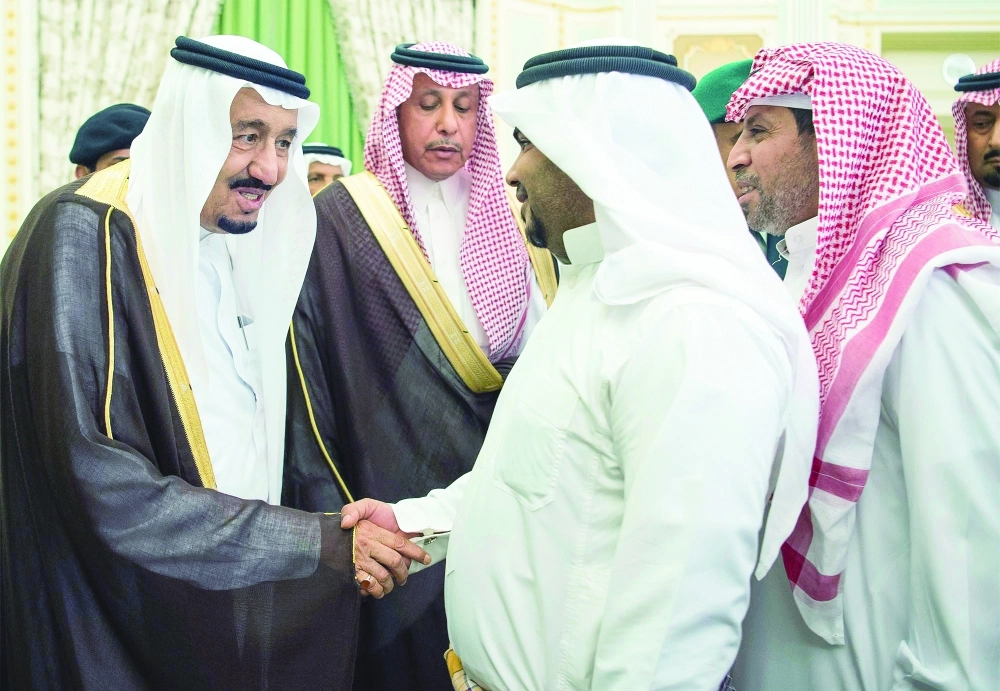 الملك سلمان مصافحا عددا من العاملين السعوديين