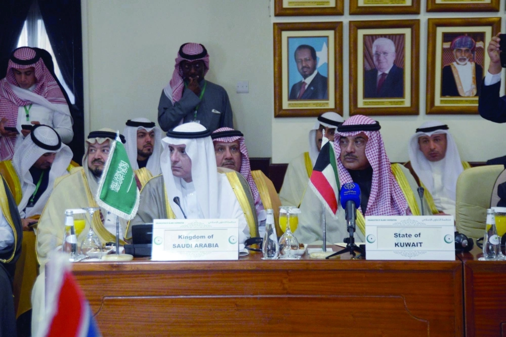 عادل الجبير (يسار) أثناء الاجتماع الطارئ لوزراء خارجية منظمة التعاون الإسلامي بجدة أمس          (محمد يحيى)