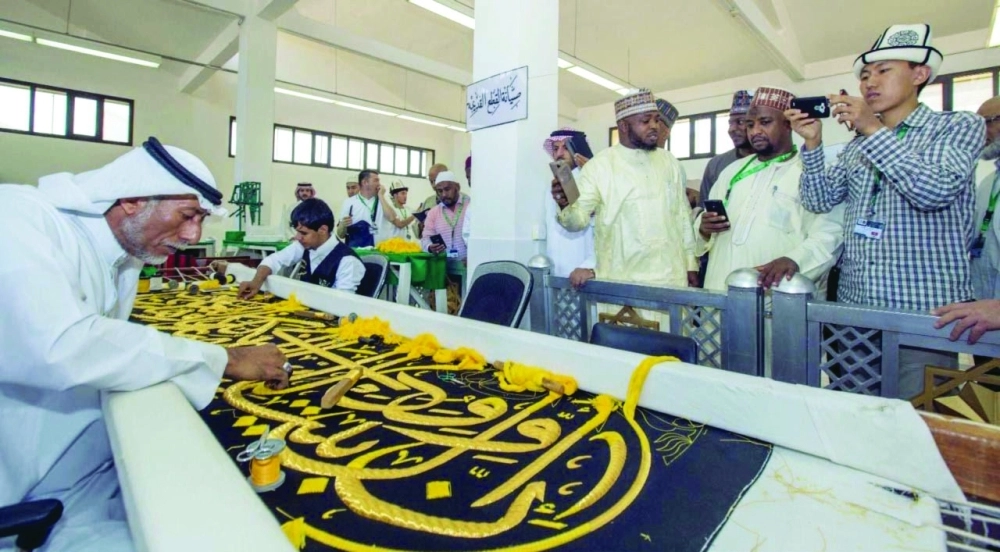 ضيوف خادم الحرمين لدى زيارتهم مصنع كسوة الكعبة (واس)