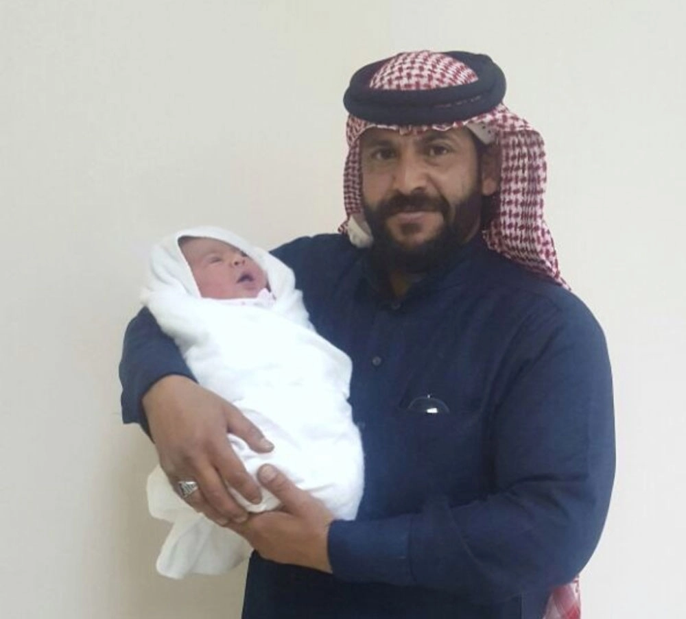 فهد العطار يحمل طفلته بعد عودتها         (مكة)      