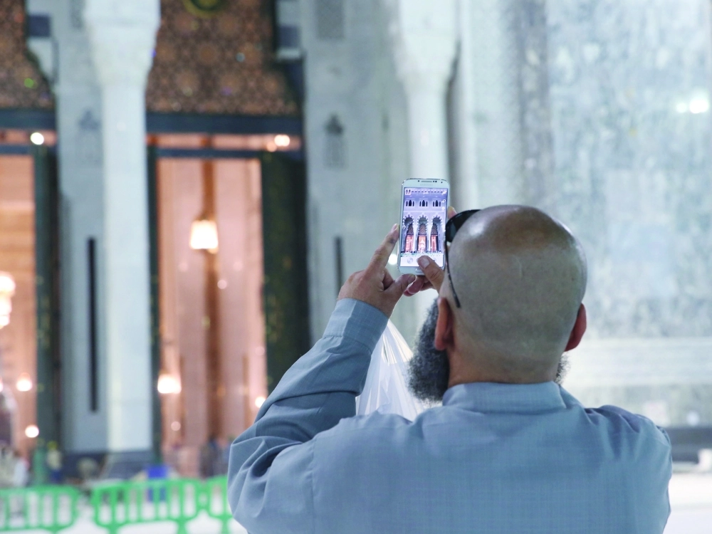معتمر يستخدم هاتفه الذكي أمام توسعة الحرم المكي                                (مكة)
