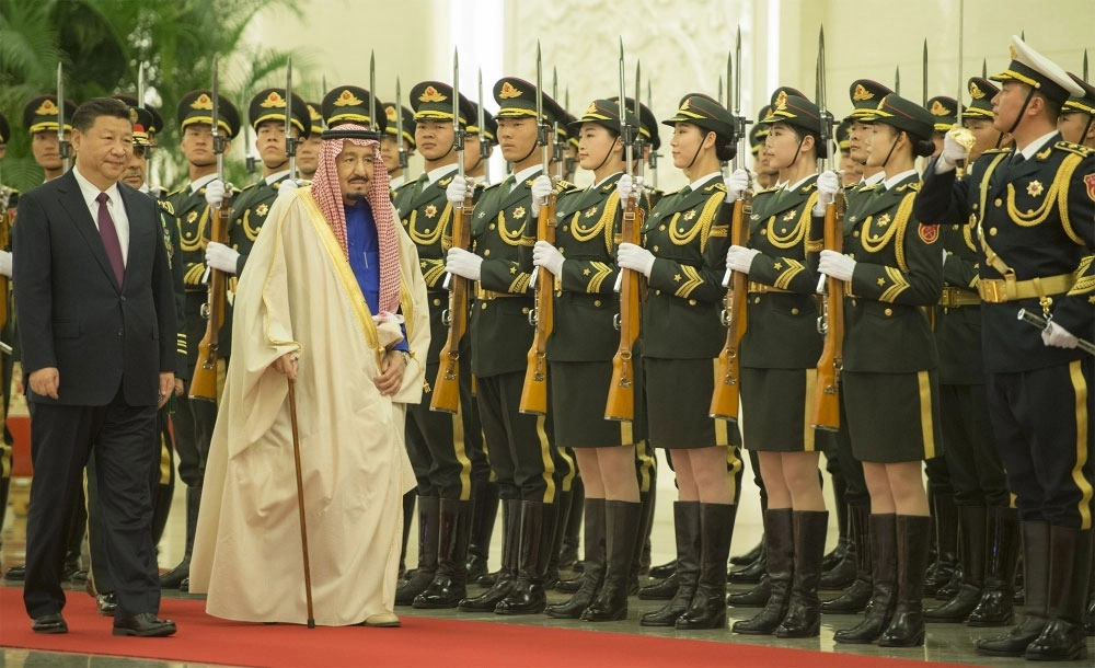 الملك سلمان مستعرضا حرس الشرف خلال مراسم استقباله من الرئيس الصيني (بندر الجلعود) 