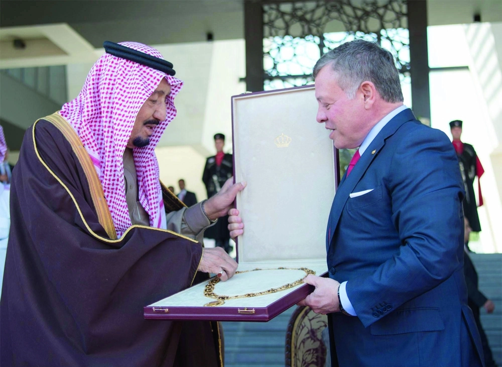 الملك سلمان خلال تقلده قلادة الشريف الحسين بن علي من الملك عبدالله الثاني