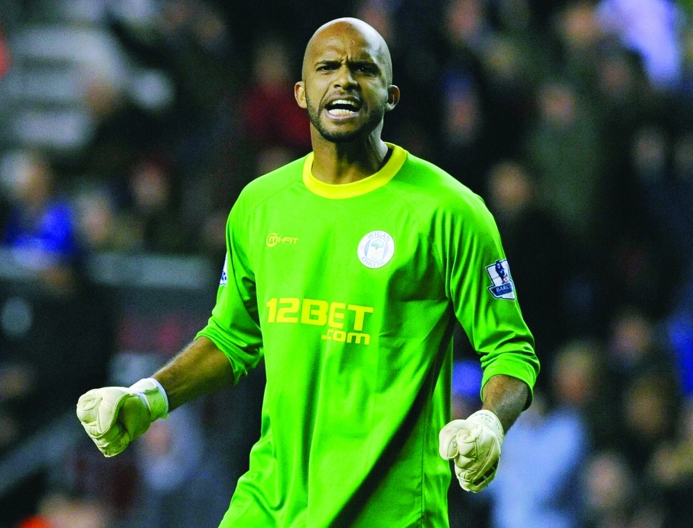 Wigan Athletic's Habsi reacts after their English Premier League soccer match against Liverpool in Wigan