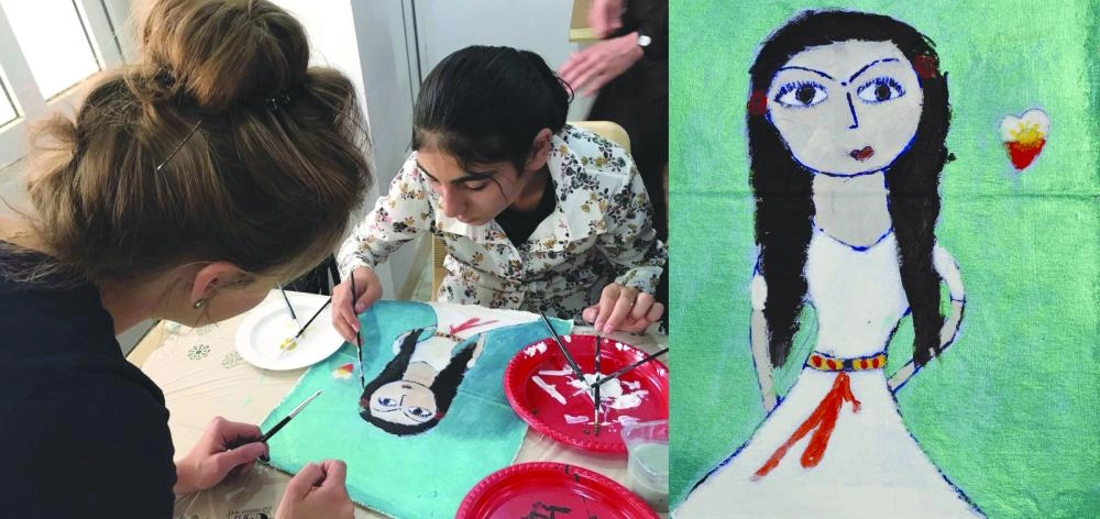 نسرين وهي ترسم لوحتها بإرشاد من هانا توماس ( Business Insider)