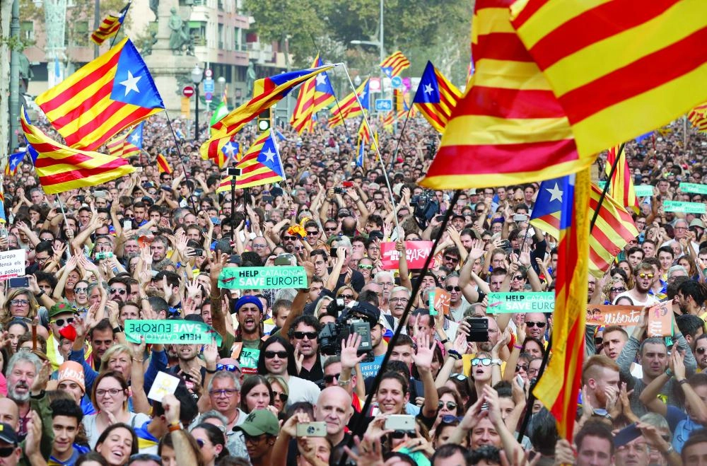 People react while the Catalan regional parliament votes for independence of Catalonia from Spain in Barcelona