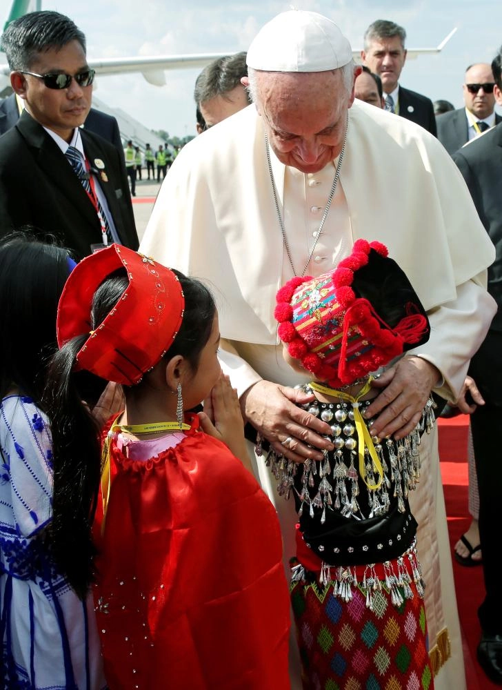 Pope Francis is welcomed as he arrives at Yangon International Airport, Myanmar November 27, 2017.  REUTERS/Max Rossi