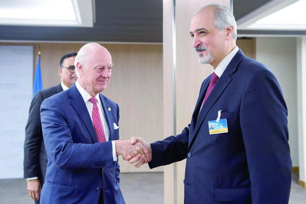 The United Nations Special Envoy for Syria, Staffan de Mistura (C) shakes hands with Bashar al-Jaafari, Syrian U.N. Ambassador, prior to a round of negotiations during the Intra Syria talks, at the European headquarters of the United Nations in Geneva, Switzerland, November 29, 2017. REUTERS/Martial Trezzini/Pool