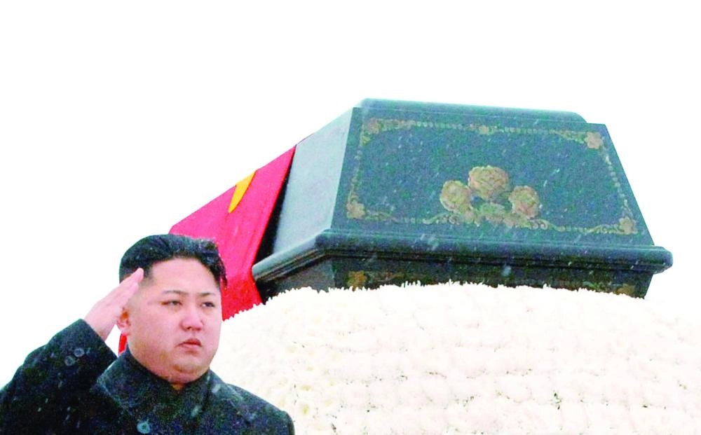 FILE PHOTO: North Korea's new leader Kim Jong-un salutes as he accompanies the hearse carrying the coffin of late North Korean leader Kim Jong-il during his funeral procession in Pyongyang in this photo taken by Kyodo December 28, 2011. To match Insight NORTHKOREA-KIMJONGUN/   Mandatory Credit Kyodo/via REUTERS/File Photo         ATTENTION EDITORS - THIS IMAGE HAS BEEN SUPPLIED BY A THIRD PARTY. MANDATORY CREDIT. JAPAN OUT.