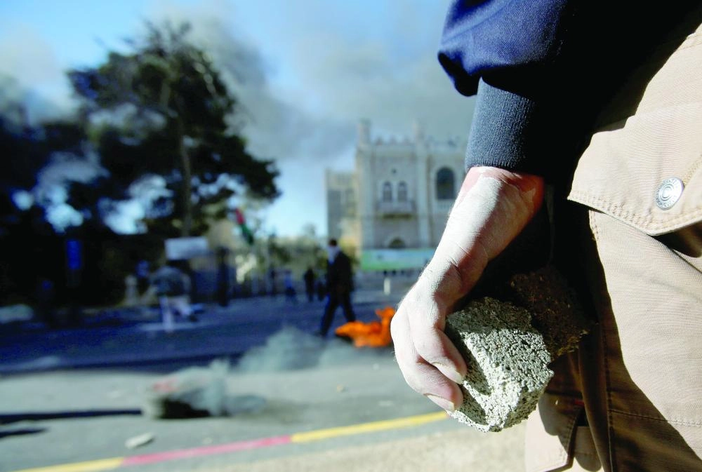 A Palestinian protester holds stones during clashes with Israeli troops in the West Bank city of Bethlehem