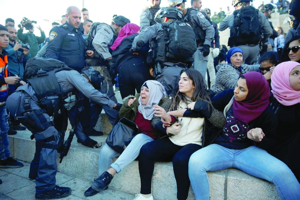 Israeli policemen scuffle with Palestinian women during scuffles at Damascus Gate after Friday prayers in Jerusalem's Old City