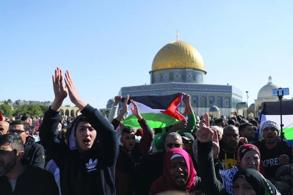 Worshippers chant as they wave Palestinian flags after Friday prayers on the compound known to Muslims as Noble Sanctuary and to Jews as Temple Mount in Jerusalem's Old City