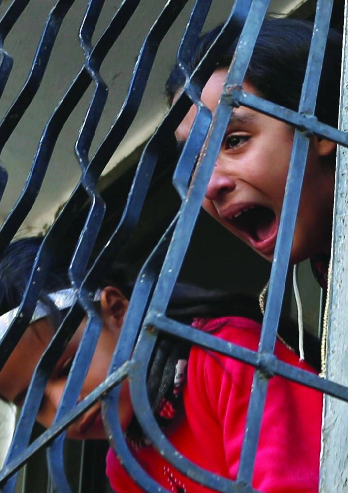 A relative of a Palestinian Hamas gunman, who was killed in an Israeli airstrike, mourns during his funeral in Gaza City December 9, 2017. REUTERS/Mohammed Salem