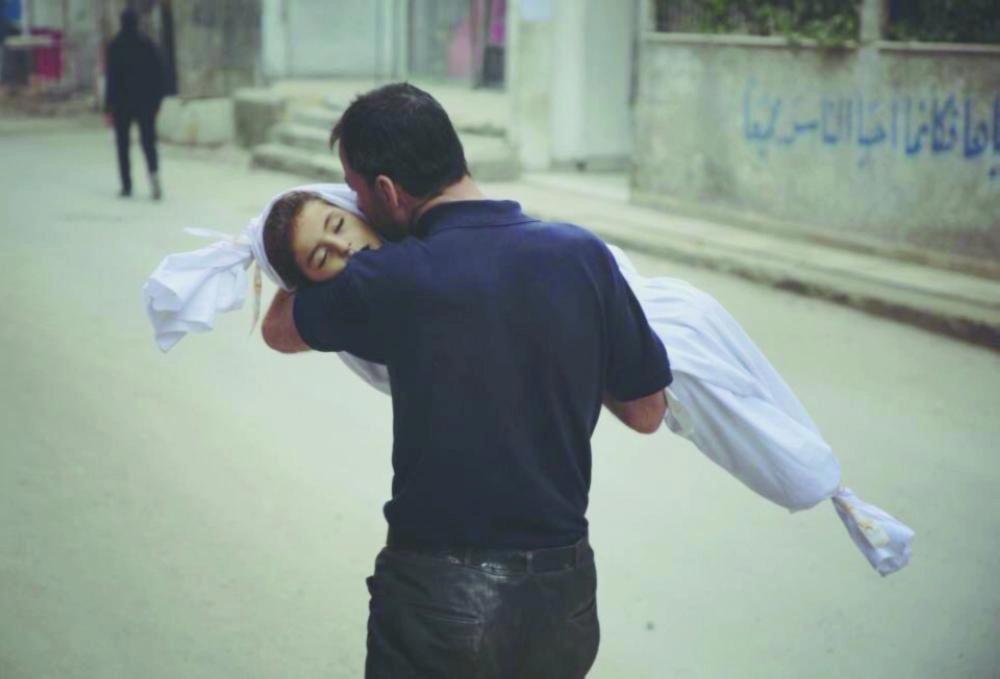 






أب يحمل طفلته التي استشهدت جراء قصف الغوطة