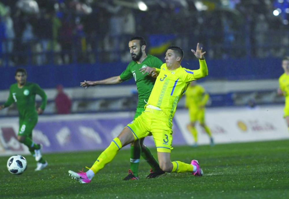 محمد السهلاوي يبحث عن الكرة أمام مدافع أوكراني (الاتحاد السعودي)