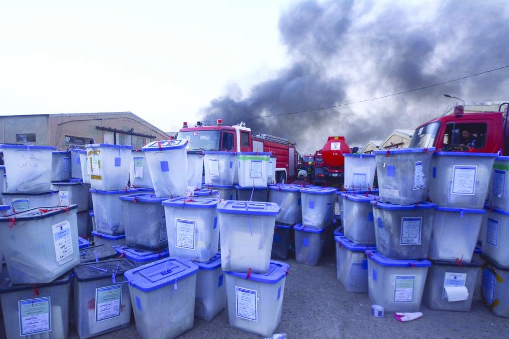 Ballot boxes are seen in front of fire trucks after a fire broke out at Baghdad's largest ballot boxes warehouse in Baghdad, Iraq, 10 June 2018. Iraq's parliament voted on Wednesday in favor of a manual ballot recount amid fraud allegations. Photo: Ameer Al Mohammedaw/dpa