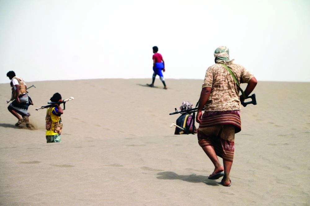 epa06868480 Yemeni government forces backed by the Saudi-led coalition take position during an attack on the port city of Hodeidah, on the outskirts of Hodeidah, Yemen, 05 July 2018 (Issued 06 July 2018). According to reports, Yemeni government forces backed by the Saudi-led coalition continue a military offensive to retake the port city of Hodeidah from the Houthi rebels.  EPA/NAJEEB ALMAHBOOBI