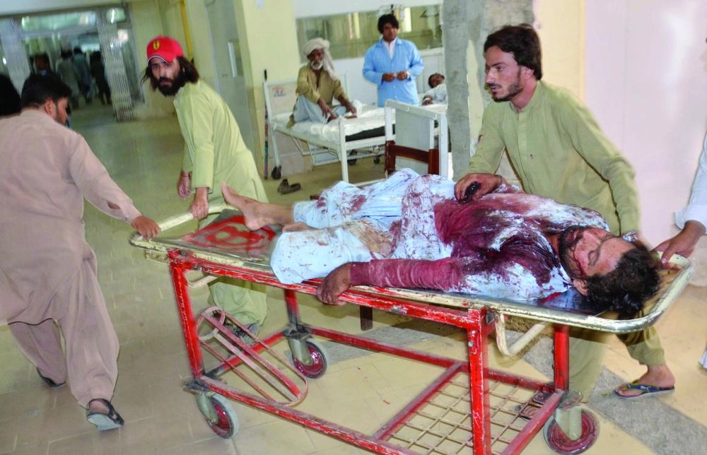 epa06885801 People shift injured victims of a suicide bomb attack that targeted an election campaign rally of Balochistan Awami Party in Mastung, to a hospital in Quetta, Pakistan, 13 July 2018.  At least 48 people including Siraj Raeesani, a BAP leader and party's candidate for General Elections, were killed in the incident. This is the third attack with casualties in ongoing campaigning for the general and provincial elections on Jul. 25, in which 105 million Pakistanis are expected to vote, according to the Election Commission of Pakistan.  EPA/JAMAL TARAQAI ATTENTION EDITORS: PICTURE MAY CONTAIN GRAPHIC CONTENT