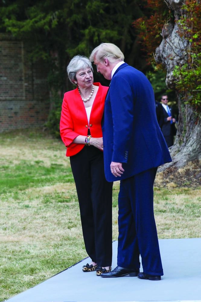 epa06885836 US President Donald J. Trump (R) with British Prime Minister Theresa May (L) leave their joint news conference after their bilateral meeting at Chequers in Aylesbury, Britain, 13 July 2018. US President Trump is on a three-day working visit to the United Kingdom, first trip to the country as US president.  EPA/CHRIS RATCLIFFE / POOL