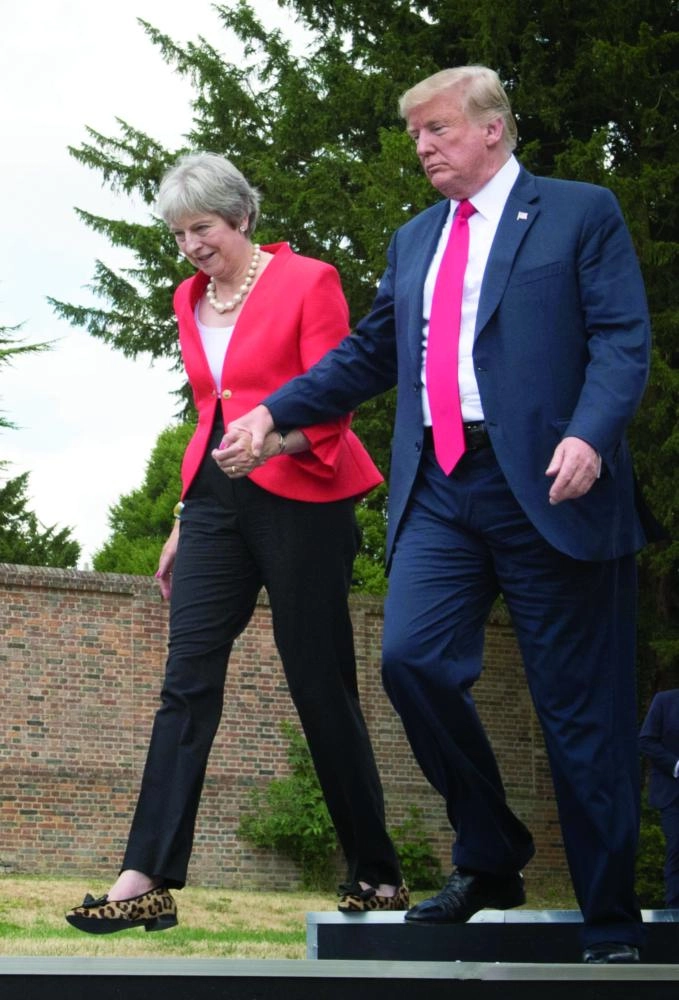 US President Donald Trump (R) and UK Prime Minister Theresa May arrive to attend a joint press conference after their meeting at Chequers, her country residence in Buckinghamshire, England, 13 July 2018. Photo: Stefan Rousseau/PA Wire/dpa