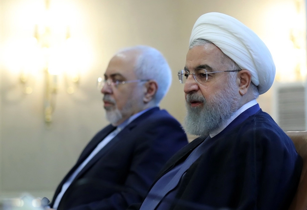 epa06903836 A handout photo made available by the Iran's Presidential office shows Iranian President Hassan Rouhani (R) and Foreign Minister Mohammad Javad Zarif (L) during a ceremony in Tehran, Iran, 22 July 2018. Media cited Rouhani threatening the US and its president Donlad J. Trump over possible plans to block oil export routes in the Persian Gulf by saying 'Do not play with the lion's tail'.  EPA/PRESIDENTIAL OFFICE HANDOUT  HANDOUT EDITORIAL USE ONLY/NO SALES