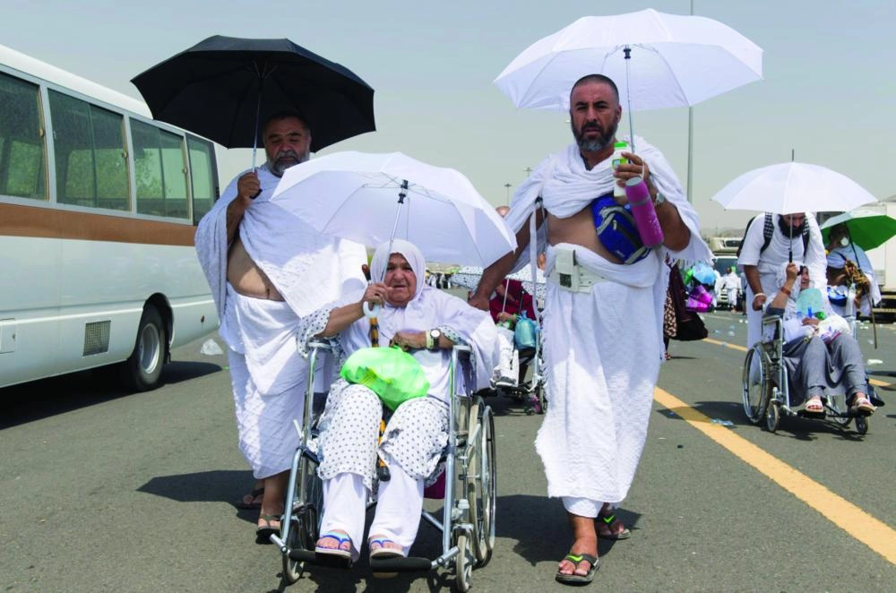 حاجان يدفعان مسنة في عرفات 