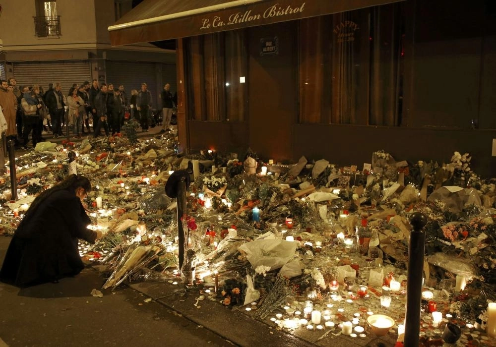 People gather outside Le Carillon restaurant, one of the attack sites in Paris