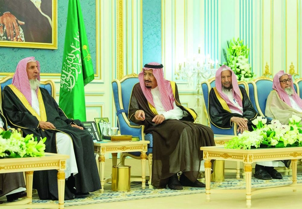 الملك سلمان لدى استقباله الأمراء والمفتي والعلماء ومواطنين في قصر اليمامة بالرياض أمس (واس)  
