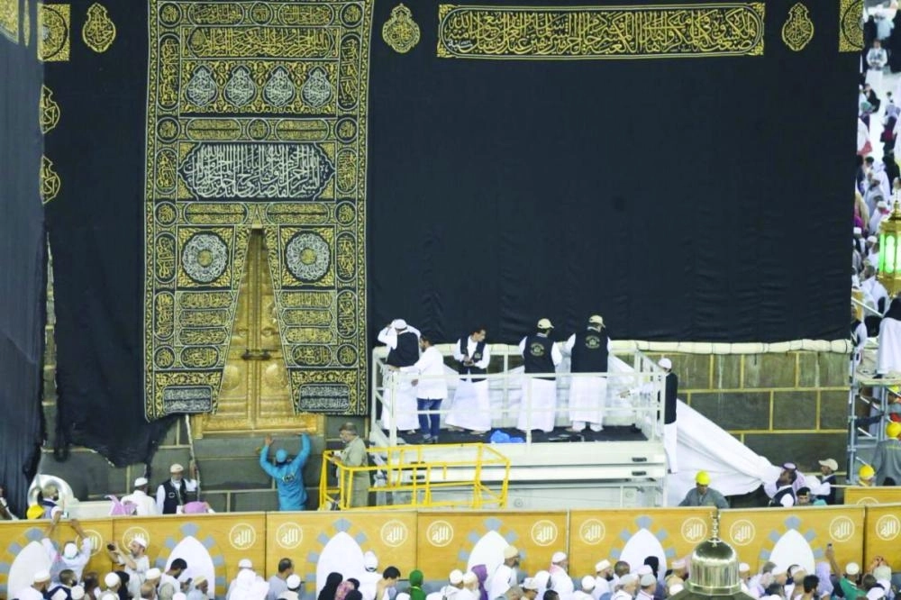 فريق العمل أثناء رفع ثوب الكعبة أمس  (مكة)