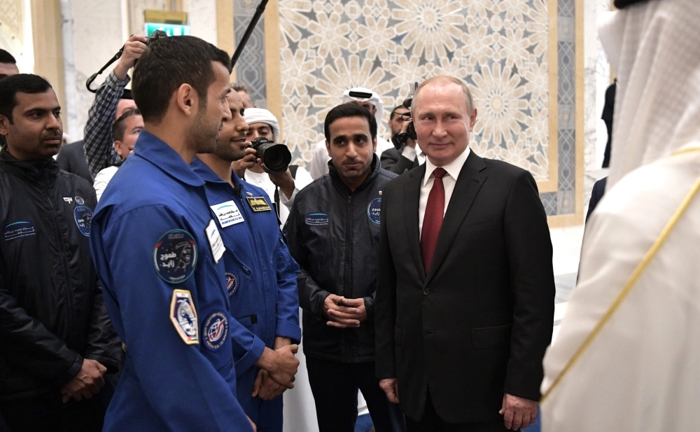 HANDOUT - 15 October 2019, United Arab Emirates, Abu Dhabi: Russian President Vladimir Putin (R) meets with Emirati astronauts Sultan Al Neyadi (2nd L) and Hazza Al Mansouri (3rd L). Photo: -/Kremlin/dpa - ATTENTION: editorial use only and only if the credit mentioned above is referenced in full