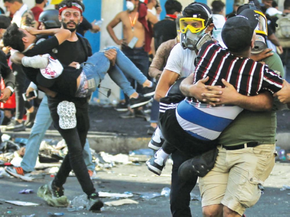 من الاحتجاجات بالعرا ق (أ ف ب)