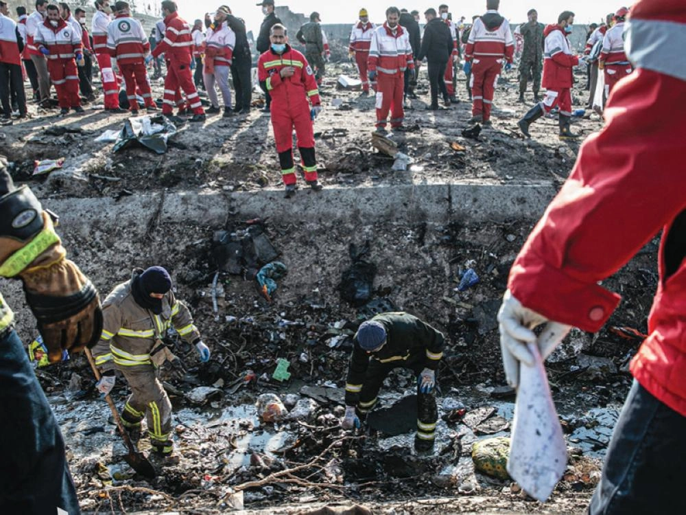 عمال الإنقاذ خلال عملية البحث في موقع تحطم الطائرة ( د ب أ )