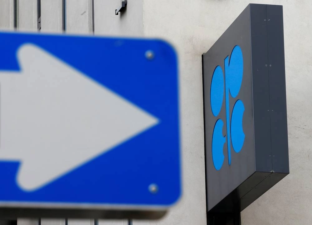 The OPEC logo is pictured behind a traffic sign at its headquarters in Vienna