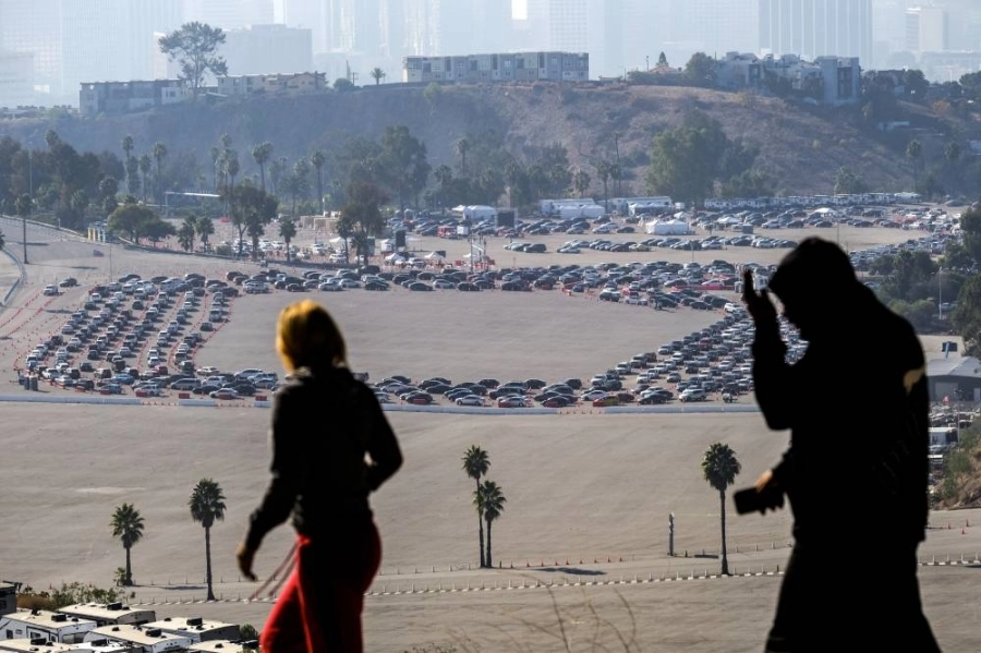 طوابير طويلة من السيارات تنتظر في موقع اختبار فيروس كورونا بساحة انتظار السيارات داخل ملعب دودجر بلوس أنجلوس في أمريكا، وموقع الاختبار هو الأكبر في الولايات المتحدة، واختبر أكثر من مليون شخص منذ افتتاحه بداية الوباء.
