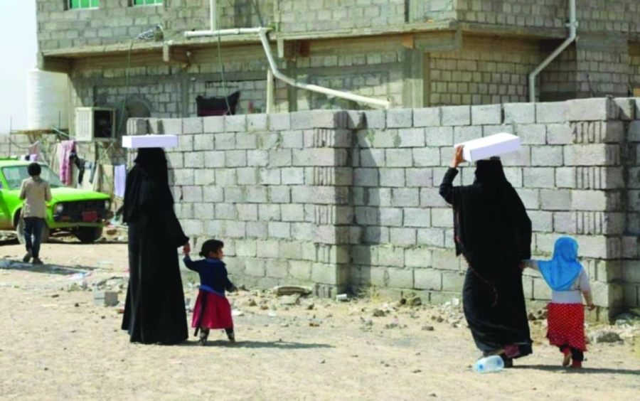 يمنيتان تحملان التمور السعودية (واس)