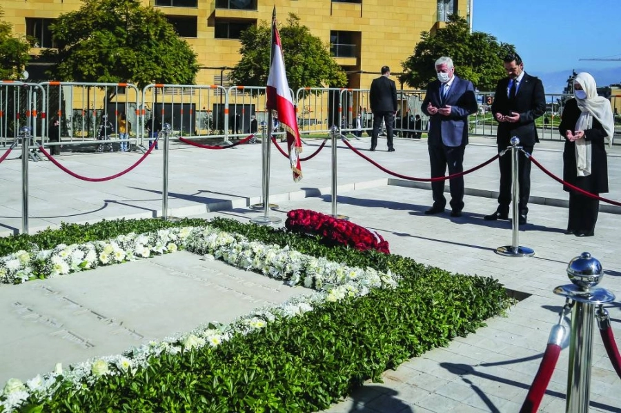 14 February 2021, Lebanon, Beirut: Lebanese designated Prime Minister Saad Hariri (C) along with his aunt Bahia (R) and uncle Shafiq recite verses of the Holy Quran and lay wreaths at the tomb of his father late Prime Minister Rafiq al-Hariri to mark the 16th anniversary of his assassination. On 14 February 2005, Rafiq al-Hariri was assassinated in a massive car bomb attack. Photo: Marwan Naamani/dpa
