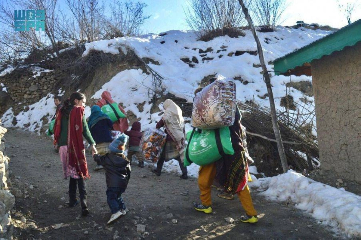 أسرة باكستانية تسلمت المساعدات تسير بين الثلوج