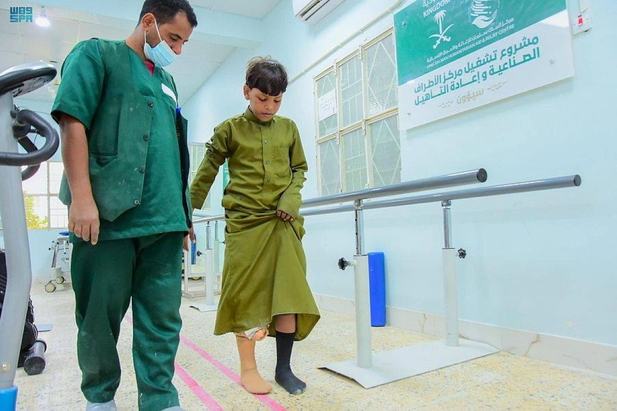 طبيب بمركز الملك سلمان يساعد طفل بعد العملية (واس)