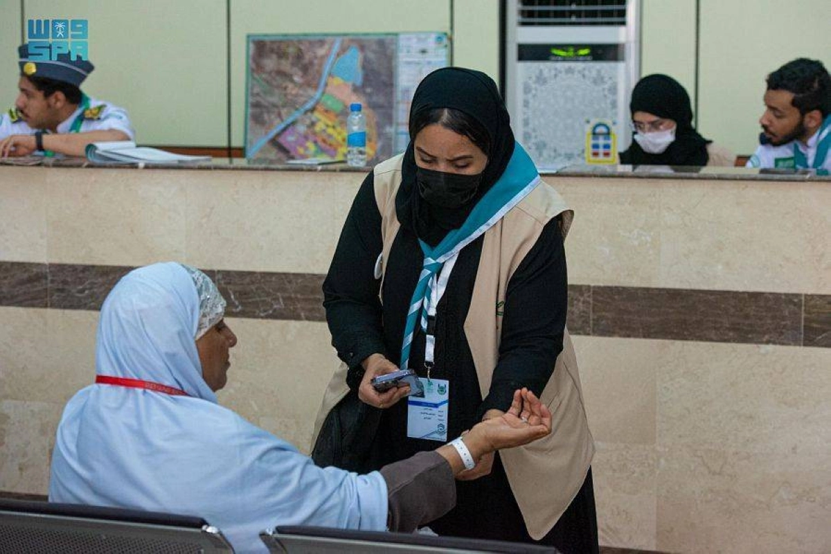 

إحدى فتيات الكشافة تساعد حاجة تائهة عن مخيمها