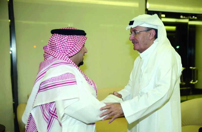 خالد بن عبدالله مصافحا الزويهري في المطار (المركز الإعلامي بالأهلي)