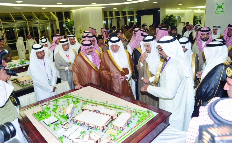 .. ومطلعا على مجسم للمشاريع ويبدو مشعل بن ماجد وخالد الفالح (علي القرني)