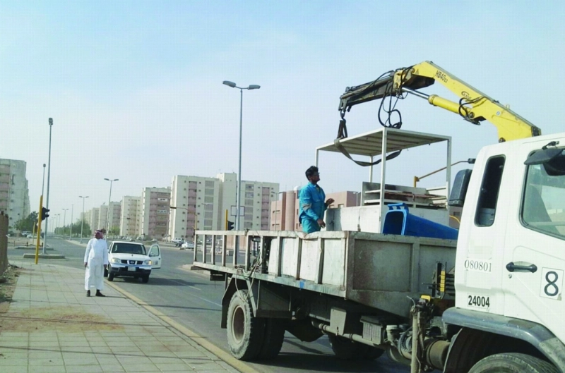 عمال خلال إزالة إحدى البسطات العشوائية (مكة)