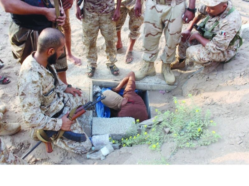 جنود بالجيش يفتشون مخبأ للأسلحة والذخائر تحت الأرض شمال عدن أمس (أ ف ب)