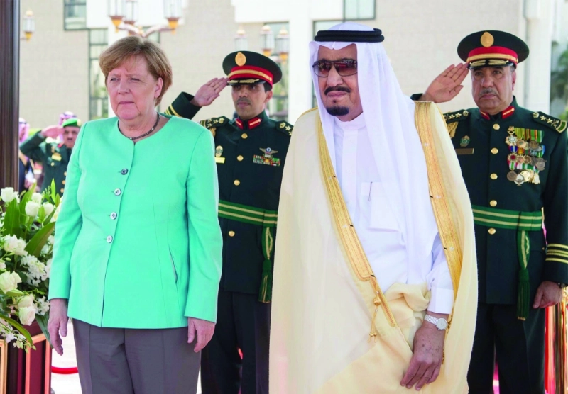 الملك سلمان وميركل خلال مراسم الاستقبال