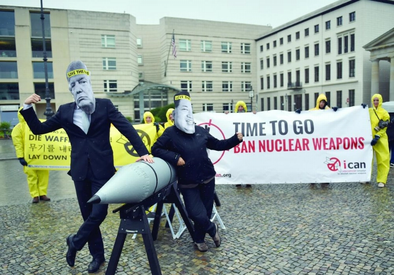 dpatop - Activists of the International Campaign to Abolish Nuclear Weapons (ICAN) wear masks depicting the US President Donald Donald J. Trump and North Korea's leader Kim Jong Unwith protest against the conflict between North Korea and the US in front of the North Korean embassy in Berlin, Germany, 13 September 2017. Photo: Britta Pedersen/dpa-Zentralbild/ZB
