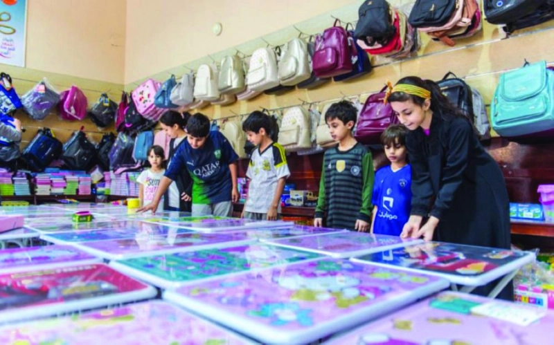طلاب وطالبات يختارون الأدوات الدراسية (واس)
