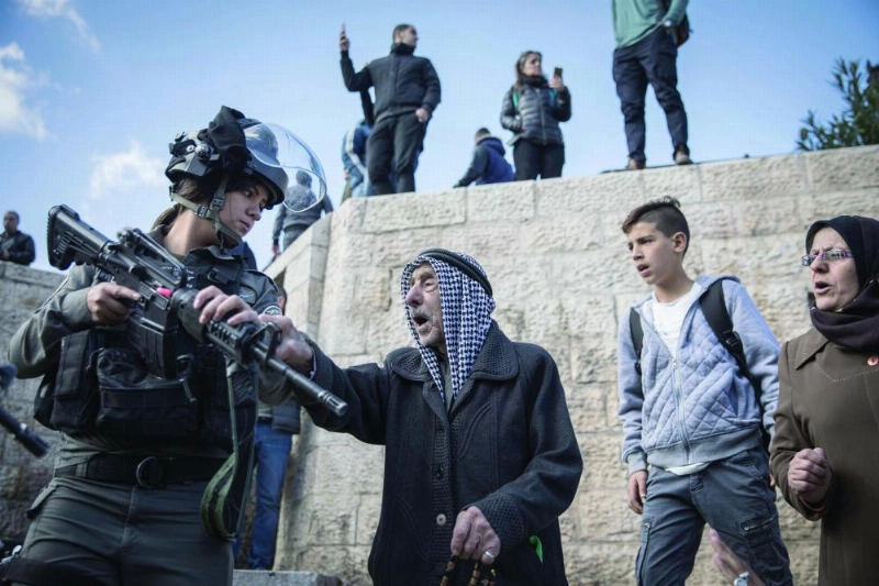 dpatop - An elderly Palestinian touches a female Israeli border police officer during a protest at the Damascus Gate of the Old City of Jerusalem, 07 December 2017. US President Trump's recognition of Jerusalem as the capital of Israel has drawn widespread international condemnation and anger. Photo: Oren Ziv/dpa