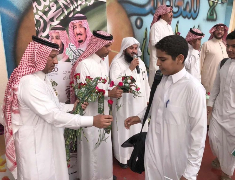 من توزيع الورود على الطلاب أمس (واس)